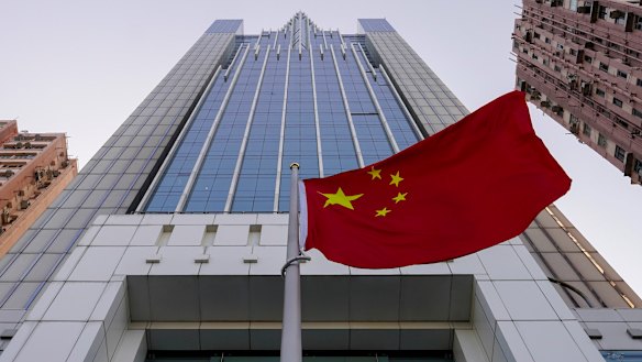 The Chinese flag flutters in the breeze outside China's liaison office building in Hong Kong.