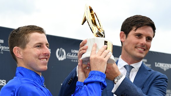 Bluewash: Lane and trainer James Cummins lift the Golden Slipper trophy after Kiamichi's upset win.
