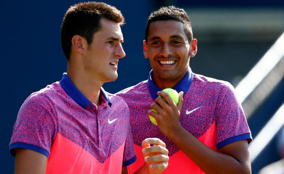 Bernard Tomic and Nick Kyrgios playing doubles at the 2014 US Open during a happier time.