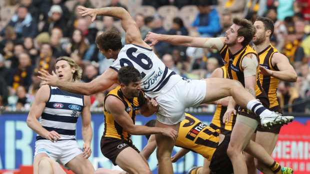 Not quite: Geelong's Tom Hawkins flies unsuccessfully for the ball.