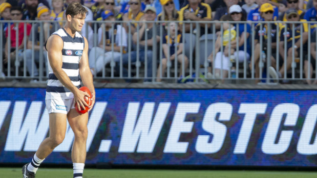Tom Hawkins lines up for goal in front of the Optus Stadium fencing.