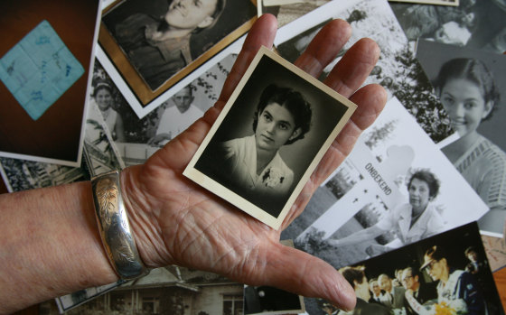 Jan Ruff O'Herne, pictured in 2008 holding a photo of herself, aged 19, just before she was taken by the Japanese.