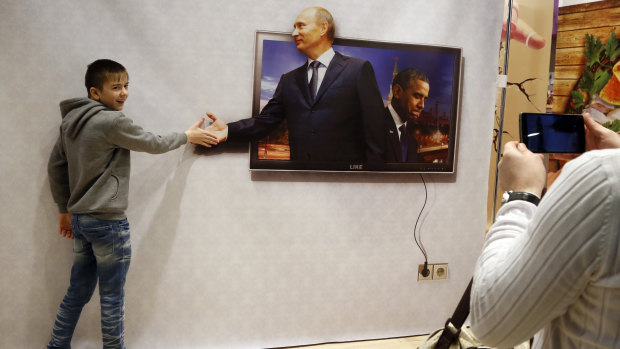 Vladimir Putin's face adorns billboard, souvenir items and television screens everywhere in Russia.