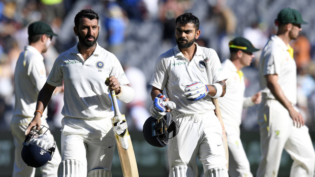 Virat Kohli, right, leaves the field after play on day one of the third cricket Test between India and Australia in Melbourne on Boxing Day, 2018.
