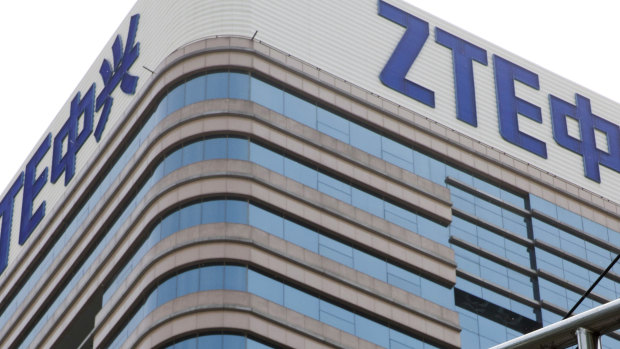 A man walks past a building with the ZTE logos in Beijing.