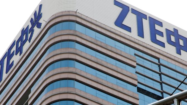 A man walks past a building with the ZTE logos in Beijing.