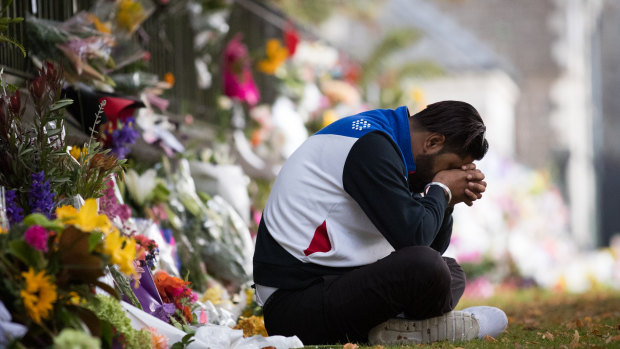 Deepak Sharma mourns at a makeshift shrine at the Botanical Gardens in Christchurch.