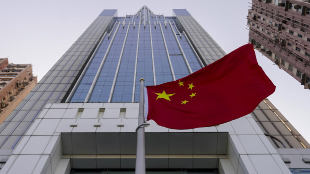 The Chinese flag flutters in the breeze outside China's liaison office building in Hong Kong.