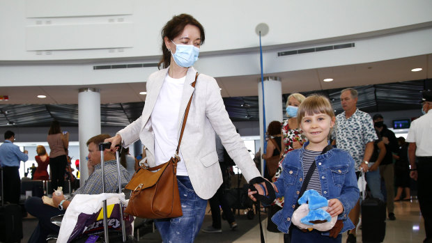 Passengers arrive at the Brisbane airport after the Queensland borders reopened to New South Wales on Tuesday. 