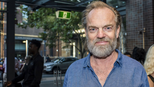 Hugo Weaving dressed in double denim for the theatrical occasion.