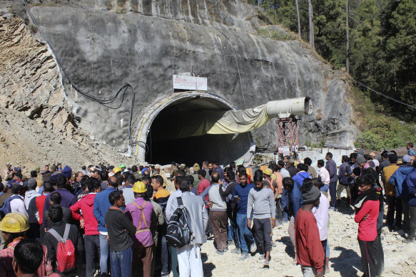 People watch rescue operations at the collapsed tunnel in mountainous Uttarakhand state, India.