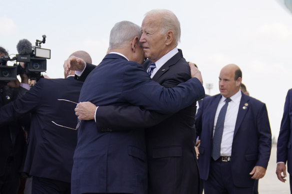 Prime Minister Benjamin Netanyahu embraces President Joe Biden after the US president arrived in Israel on October 18.