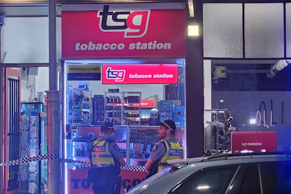 Police at the scene of a tobacco shop robbery on Thursday