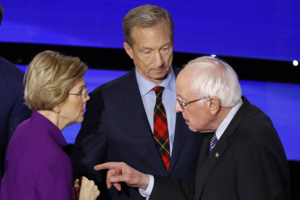 Elizabeth Warren and Bernie Sanders on Tuesday after their Democratic presidential primary debate. Candidate Tom Steyer looks on.