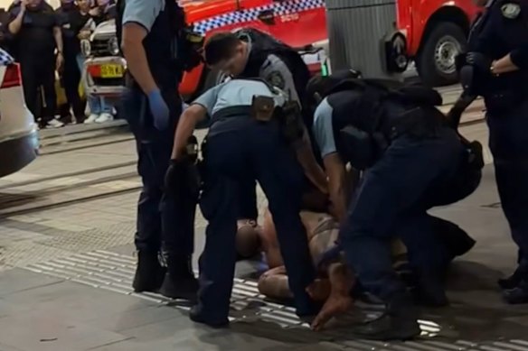 Police arrest the bloodied man after the collision in the Sydney CBD on October 8. 