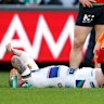 Warriors skipper Mitchell Barnett receives treatment on his injured knee on Sunday. 