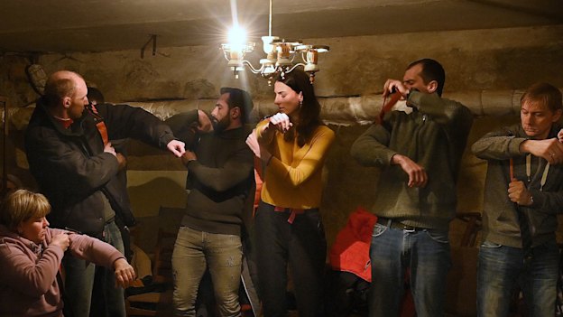 Civilians learned how to apply a tourniquet in an underground shelter during an air raid in Dnipro. 