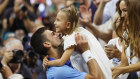 Novak Djokovic lifts his daughter Tara after defeating Daniil Medvedev to win the US Open.