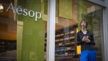 Designer Jessie French with the algae-based decal she has created on the window of retail Aesop’s Collins Street store in Melbourne.