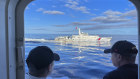 A Chinese coast guard vessel manoeuvres beside the Philippine coast guard ship BRP Cabra as they approach Second Thomas Shoal on Friday.