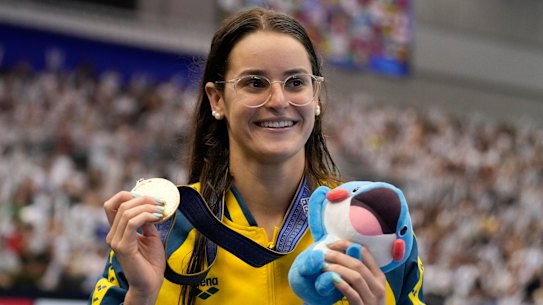 Kaylee McKeown with her gold medal after the women’s 100m backstroke final at the world swimming championships. 