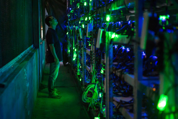 A manager checks equipment in a bitcoin mine in Sichuan, China.