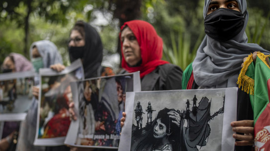 Afghan women hold placards during a protest in New Delhi.