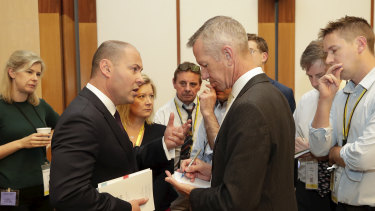 Treasurer Josh Frydenberg speaks with Peter Hartcher during the Budget lockup at Parliament House in Canberra on  Tuesday 2 April 2019. 