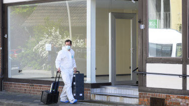 A crime scene officer arrives at an apartment in Wittingen where the bodies of two women were found on Monday.