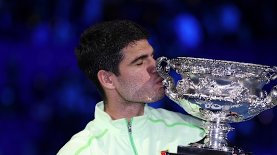 Carlos Alcaraz celebrates with his trophy.