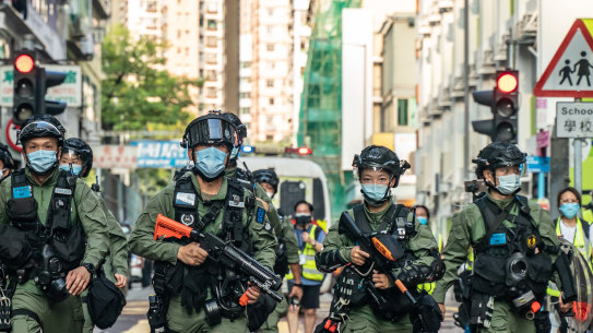 Riot police in Hong Kong head toward an anti-government protest on September 6.