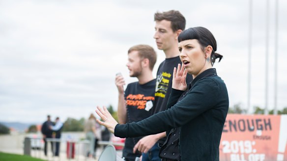 Auslan interpreter Lauren Napper-Ferrari with National Union of Students disabilities officer Will Edwards (left) and Australian National University refugee action committee organiser Caspian Jacobsen at Friday's rally.