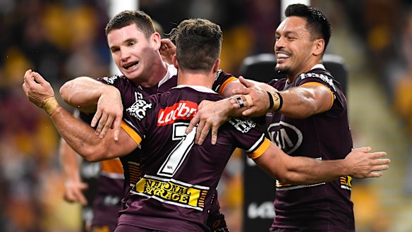 Broncos players celebrate during their win over the Cowboys on Friday night at Suncorp Stadium.
