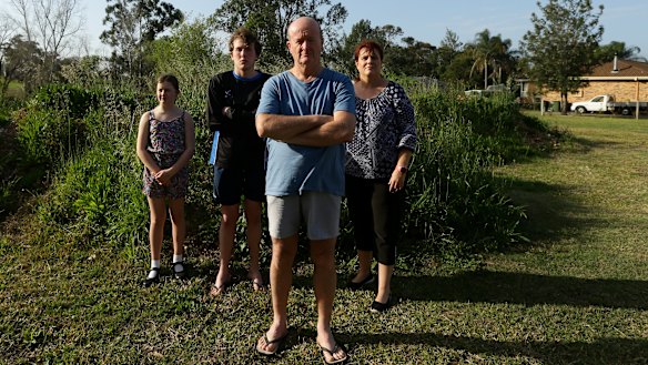 The Heald family in front of their demolished house.