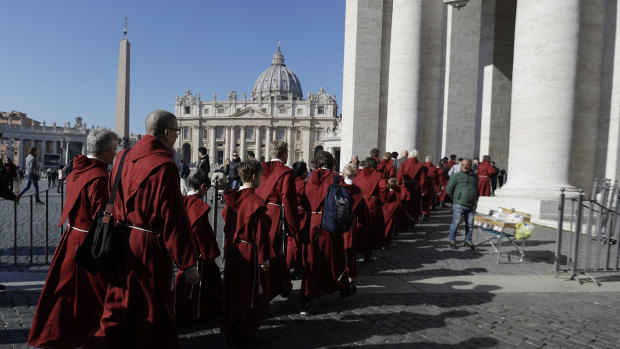 Faithful arrive in St. Peter's Square to attend Pope Francis' Angelus noon prayer at the Vatican.