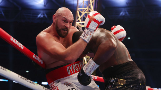 Tyson Fury holds onto Dillian Whyte.