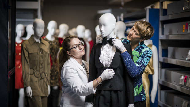 Skye Firth (left) and Katie Somerville of the National Gallery of Victoria prepare 'The Krystyna Campbell-Pretty Fashion Gift' exhibition.