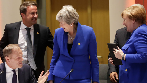 EC President Donald Tusk, left, speaks with British Prime Minister Theresa May, centre, German Chancellor Angela Merkel, right, and Luxembourg's PM Xavier Bettel, second left, prior to a dinner during an EU summit in Brussels. 