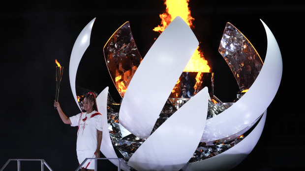 Japan’s Naomi Osaka reacts after lighting the cauldron.