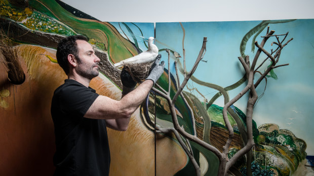Giovanni Di Dio, acting manager of exhibitions at Art Gallery of Western Australia, installing Brett Whiteley's The American Dream.