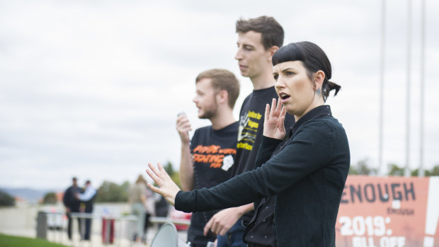 Auslan interpreter Lauren Napper-Ferrari with National Union of Students disabilities officer Will Edwards (left) and Australian National University refugee action committee organiser Caspian Jacobsen at Friday's rally.