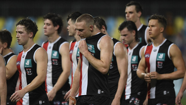 The Saints walk from the field after giving up a commanding lead against Adelaide.