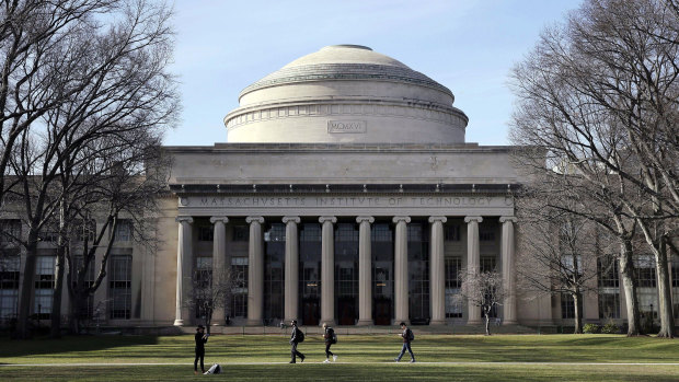 Students walk past the "Great Dome" atop Building 10 on the Massachusetts Institute of Technology campus in Cambridge, Massachusetts. 