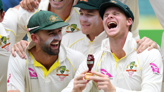 Former Australian cricket captain Steve Smith celebrates holding a replica of The Ashes urn after a win in January 2018.