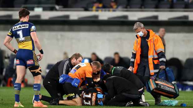 Michael Chee Kam of the Tigers is attended to by medicos after suffering a seizure at Bankwest Stadium.