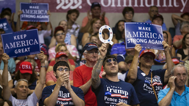 A supporter of US President Donald Trump holds up a sign referencing QAnon, a fringe movement that discusses several loosely connected and vaguely defined conspiracy theories, during a rally in Pennsylvania.