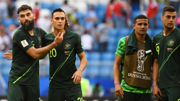 Benched: Tim Cahill (second from right) with teammates after the 1-1 draw with Denmark.