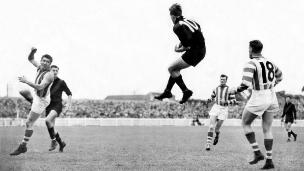 Essendon legend John Coleman flies for a mark against North Melbourne in 1952.