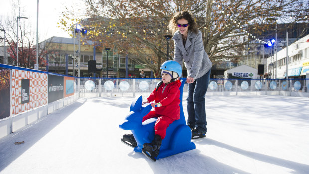 Nicole Johnson and Ivy, four, ice skating at Canberra's Wintervention festival.