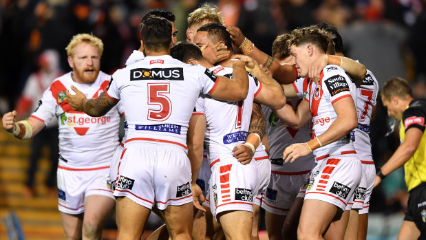 Back on track: Tyson Frizell is mobbed by teammates after scoring.